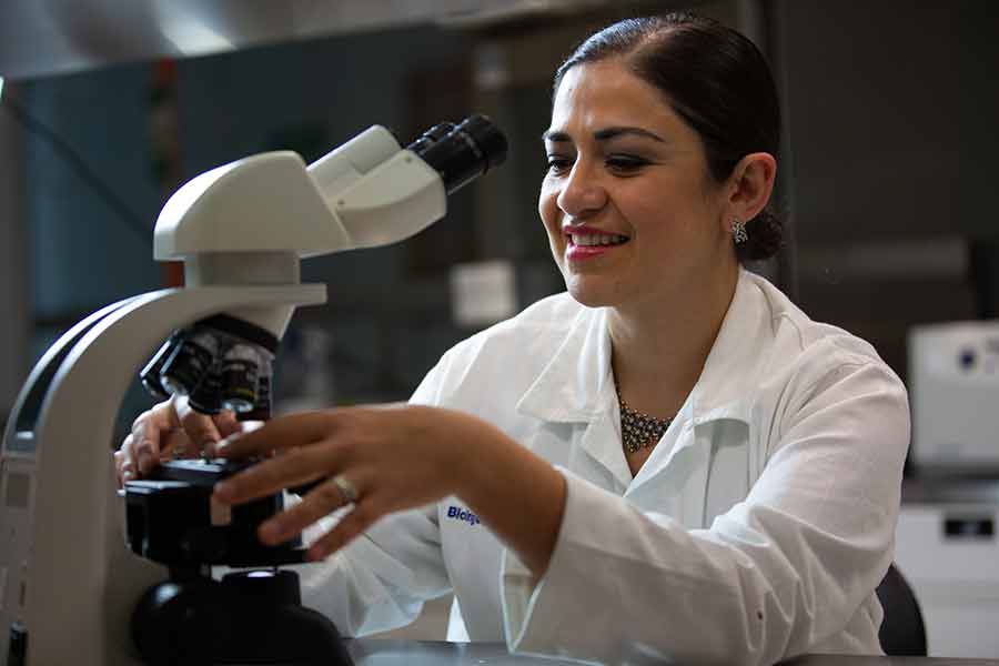 La doctora Janet Gutiérrez observando un microscopio