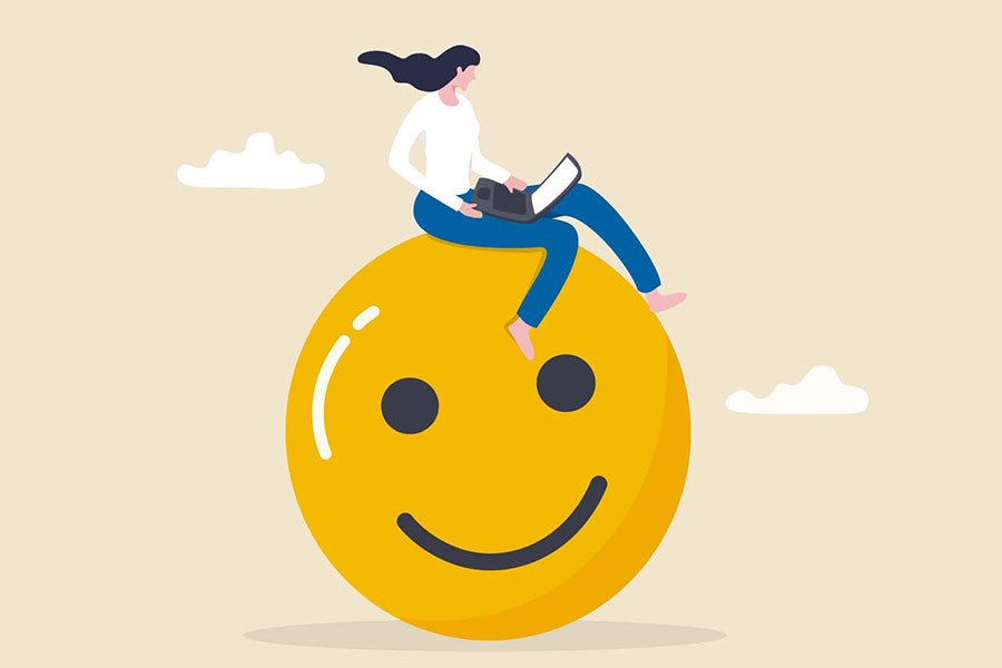Ilustración conceptual de felicidad en el trabajo, con una chica trabajando en su laptop, sentada sobre un emoji gigante de carita feliz