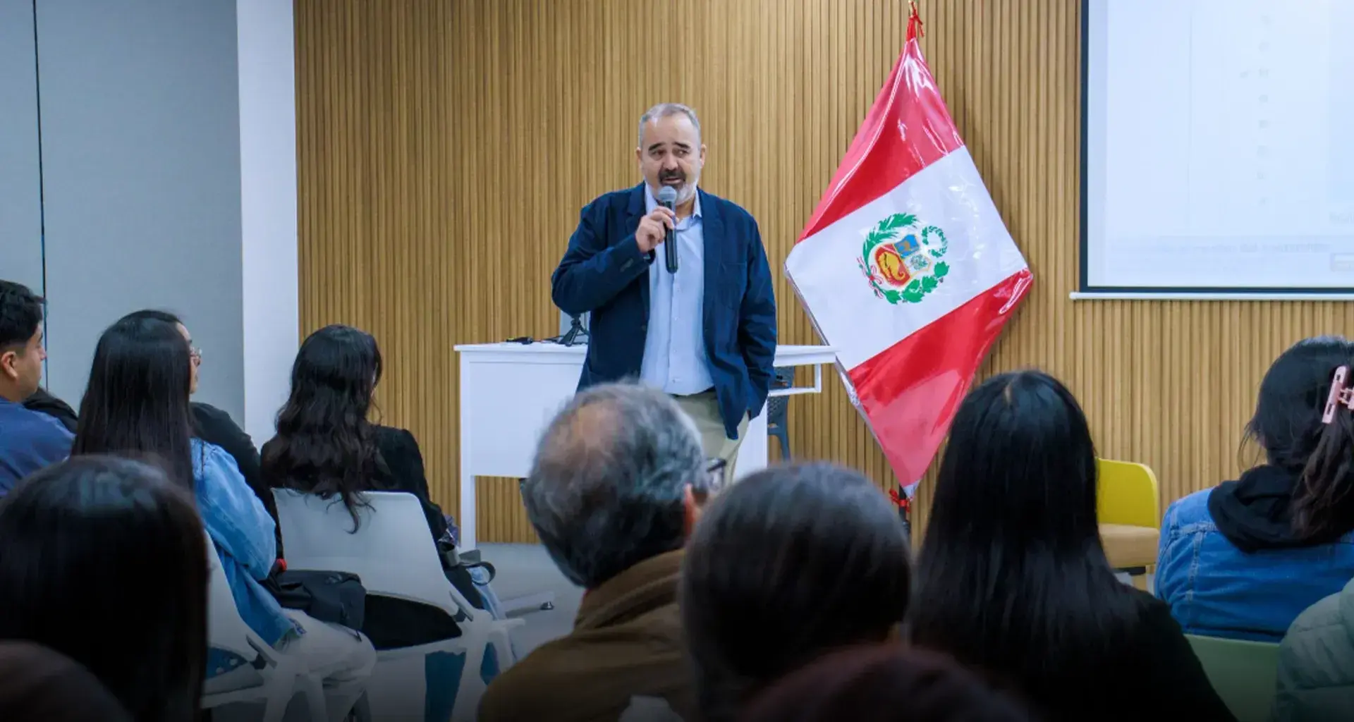 Professor speaking in front of an audience.