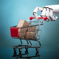 Robot sosteniendo un carrito de compras con cajas de cartón sobre fondo turquesa