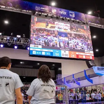 Voluntarios vigilan y apoyan a través de una pantalla lo que sucede en FIRST Regional Laguna 2025